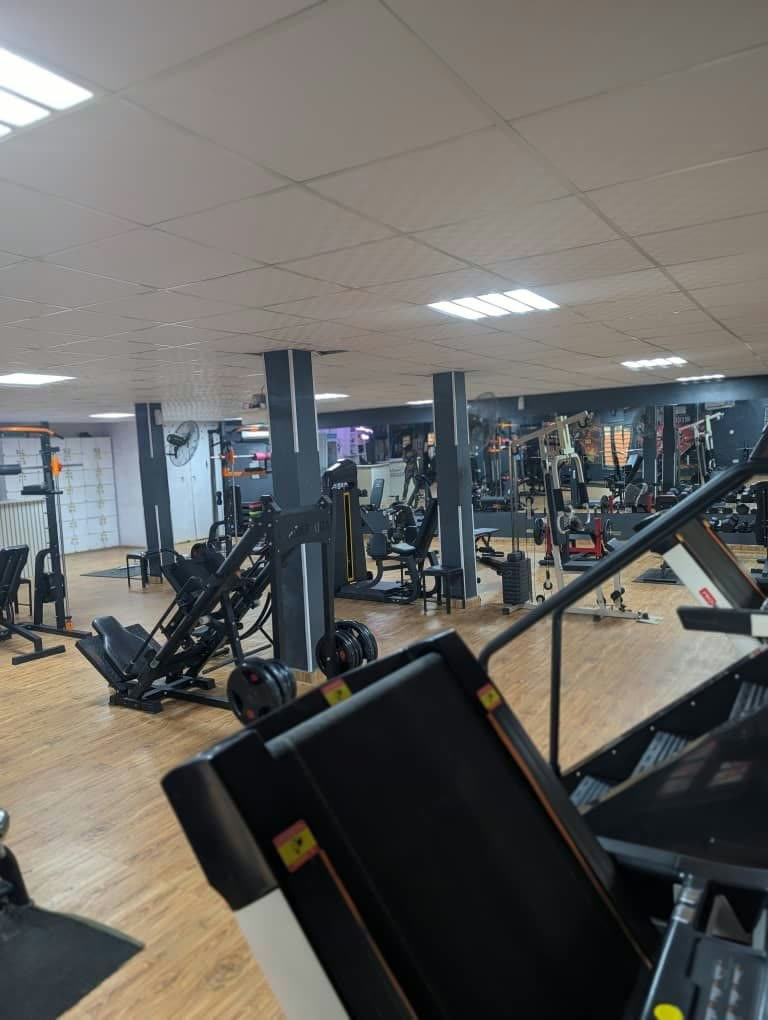 NathJay Fitness training floor with leg press and cardio equipment